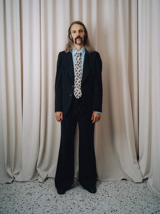 Dancing Balera Jacket in black, full figure with paisley tie and flared trousers