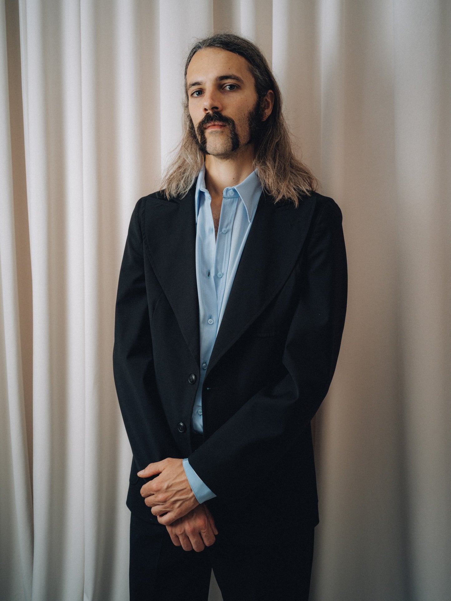 Dancing Balera Jacket in black over a light blue shirt, half-length view of the lapel