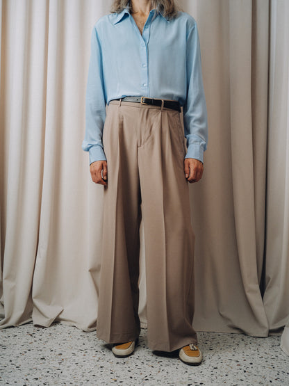 VIP 76 Shirt in light blue tucked into taupe trousers with a black belt