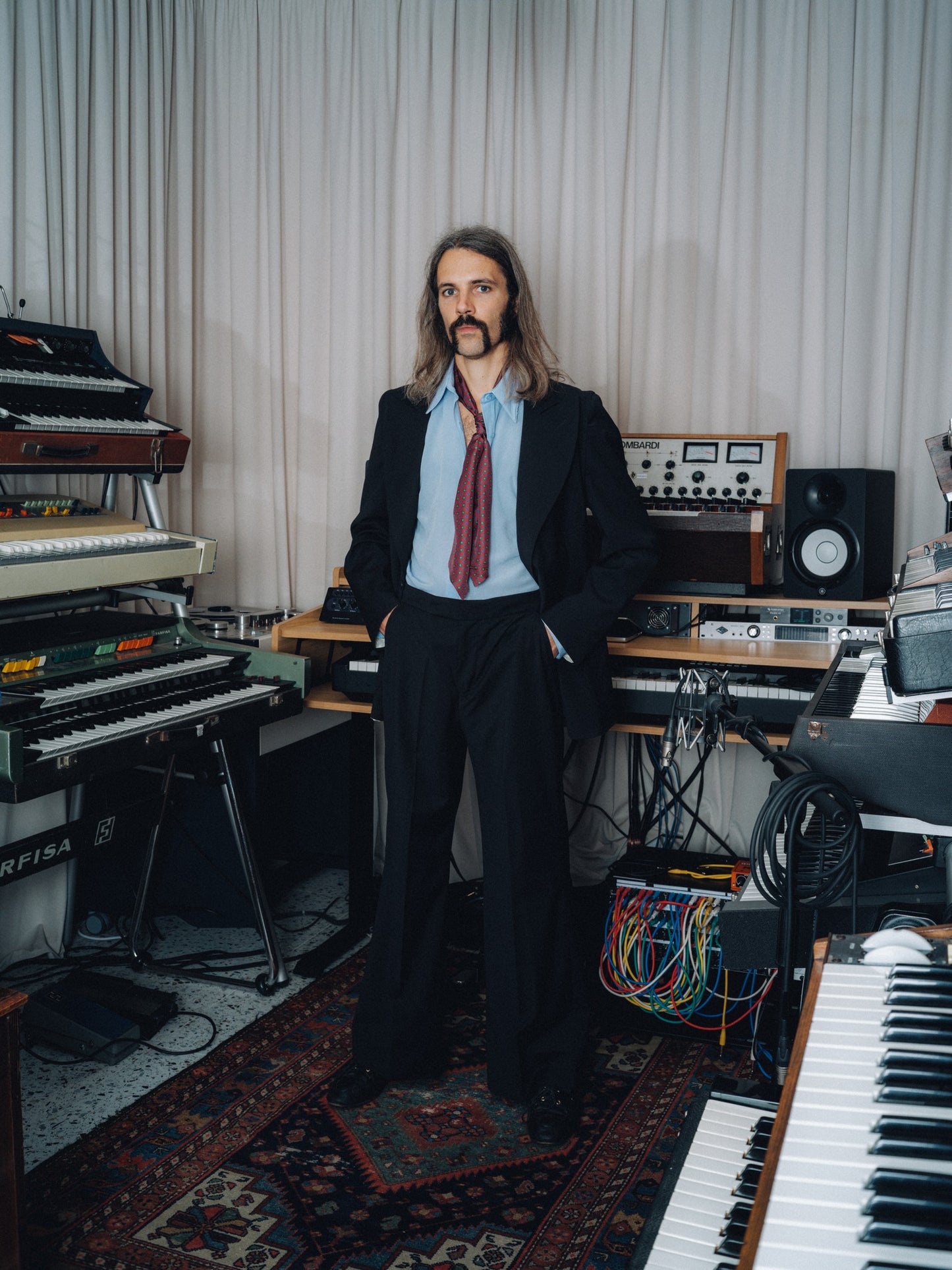 Black Dancing Balera jacket and matching trousers with a burgundy ascot in a synthesizer studio